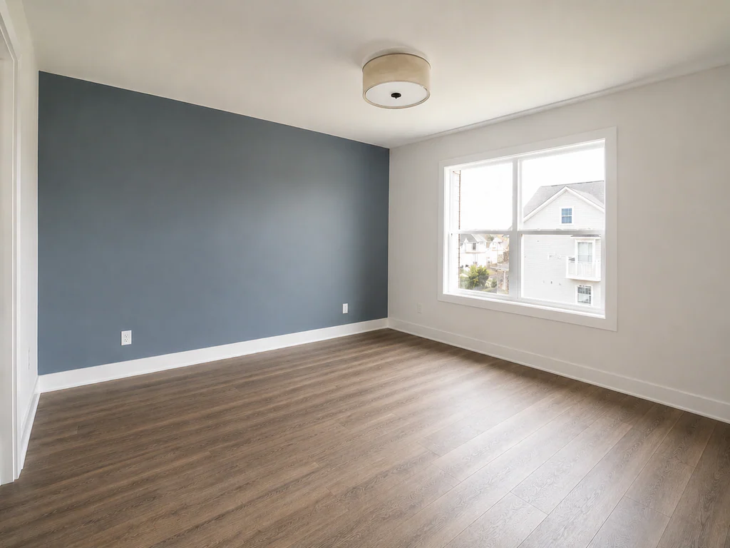 Kids' bedroom before virtual staging: room with a blue accent wall and large window, shown empty.