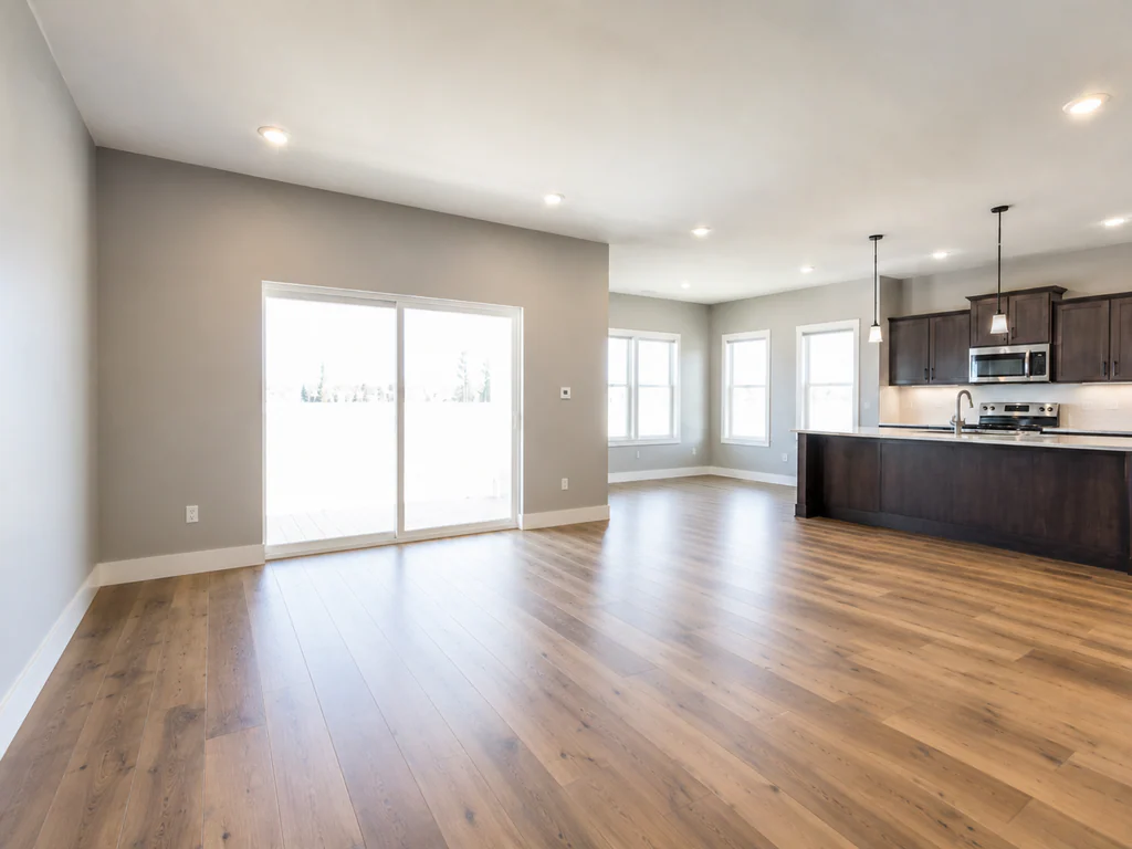 Living room before virtual staging: open-plan room with a dark wood kitchen, shown empty.